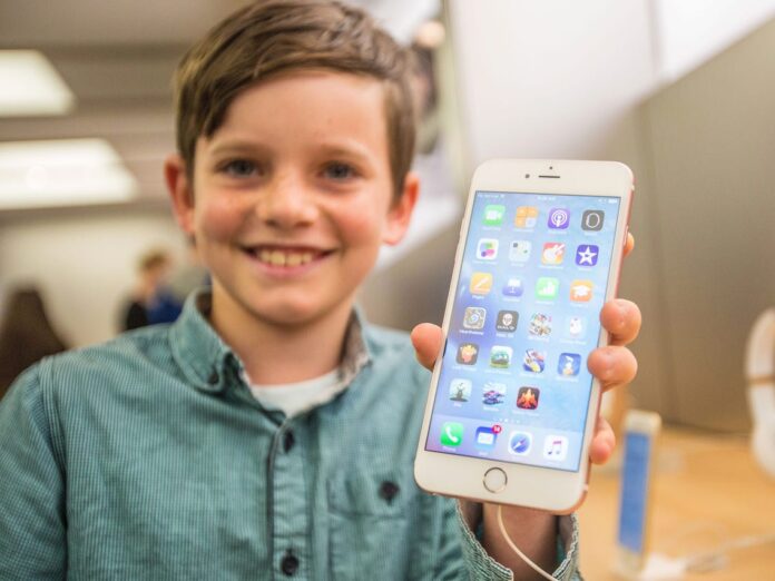 Kid Holding An Iphone